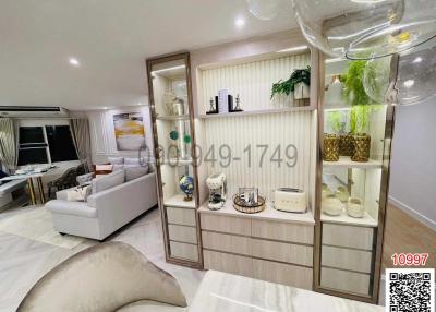 Spacious and stylishly decorated living room with comfortable seating and shelving units
