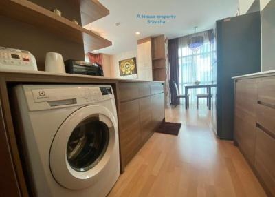 Modern kitchen with wooden cabinets and washing machine