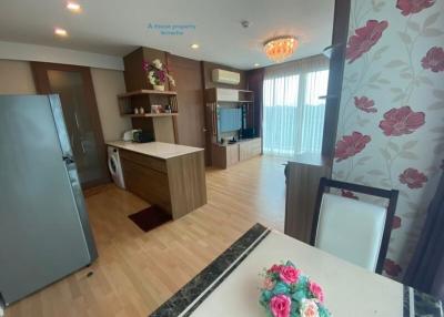 Modern kitchen with integrated appliances and a view into the living area