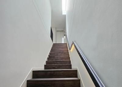 Modern staircase with wooden steps and white walls in a residential home