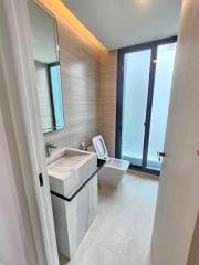 Modern bathroom interior with large mirror and glass door