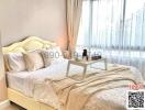 Elegantly furnished bedroom with a cozy bed and ample natural light