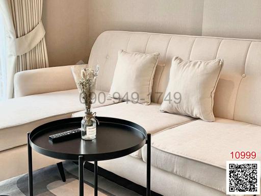 Modern living room with beige sofa and black round coffee table