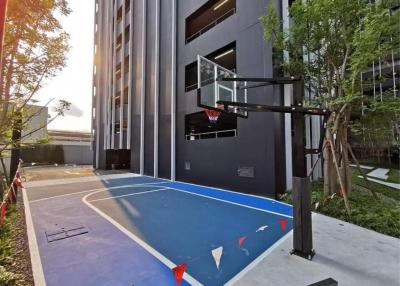 Outdoor basketball court adjacent to residential building