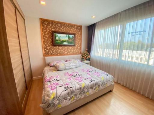 Spacious bedroom with large bed and decorative headboard