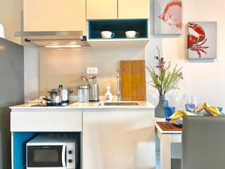 Modern kitchen with stainless steel appliances and colorful wall decorations