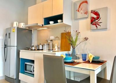 Modern kitchen with stainless steel appliances and a dining area