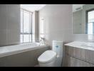 Modern bathroom with bathtub and neutral color tiles