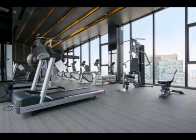 Modern gym facility with exercise equipment and city view