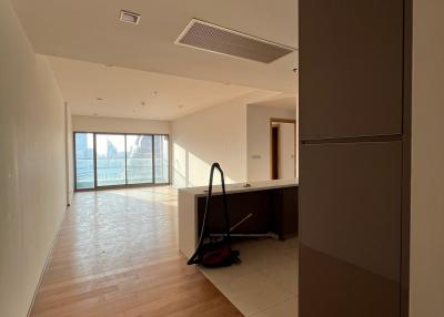 Spacious living room with hardwood flooring and abundant natural light