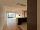 Spacious living room with hardwood flooring and abundant natural light