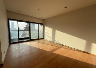 Spacious living room with large windows and hardwood floors