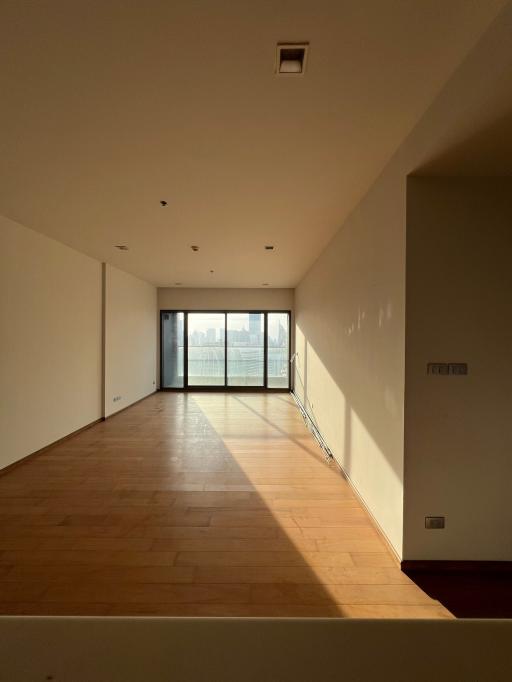 Spacious living room with natural light and a balcony