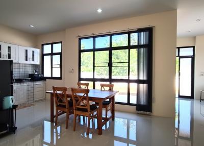 Spacious kitchen with dining area, modern appliances, and large windows