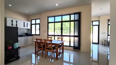 Spacious kitchen with dining area, modern appliances, and large windows