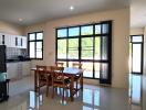 Spacious kitchen with dining area, modern appliances, and large windows