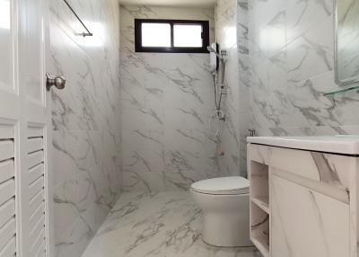 Modern marble bathroom with white fixtures
