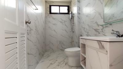 Modern marble bathroom with white fixtures