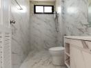 Modern marble bathroom with white fixtures