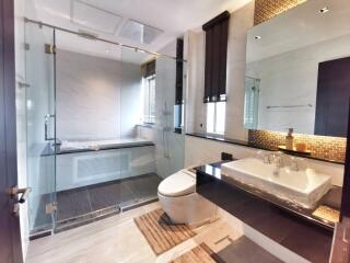 Modern bathroom with bathtub and glass shower enclosure