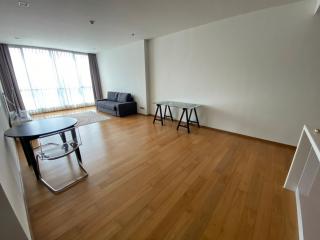 Spacious living room with hardwood floors and natural lighting