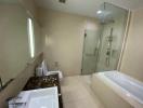 Spacious bathroom with modern fixtures, including a bathtub, walk-in shower, and vanity