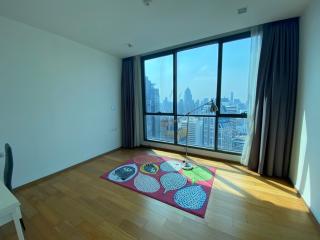 Spacious bedroom with large window and city view