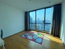 Spacious bedroom with large window and city view