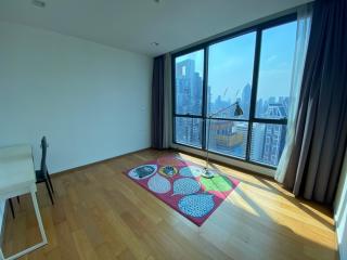 Spacious living room with large windows and city view