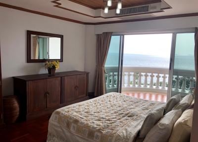 Spacious bedroom with sea view and balcony access