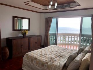 Spacious bedroom with sea view and balcony access