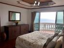 Spacious bedroom with sea view and balcony access