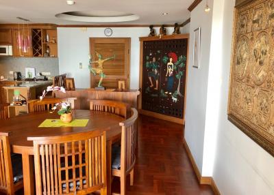 Spacious dining room with wooden furniture and decorative artwork