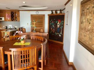 Spacious dining room with wooden furniture and decorative artwork