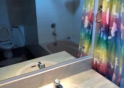 Modern bathroom with colorful shower curtain and clean facilities