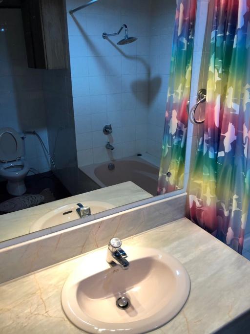 Modern bathroom with colorful shower curtain and clean facilities