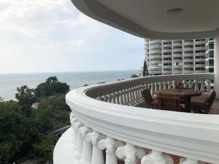 Spacious balcony with a dining table overlooking the sea