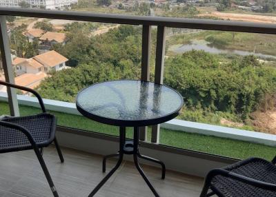 Balcony with a view of the cityscape and a small table with chairs