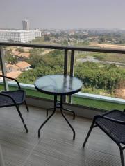 Balcony with a view of the cityscape and a small table with chairs