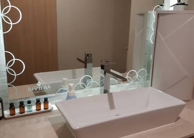 Modern bathroom sink with vanity mirror and toiletries