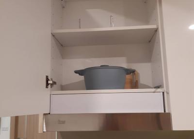 Kitchen cabinet with pots and dishes