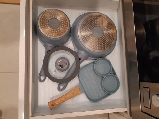 Kitchen drawer with pots and kitchen utensils