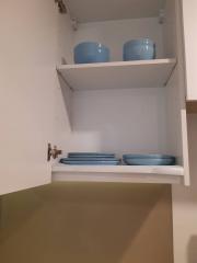 Open kitchen cabinet with dishes