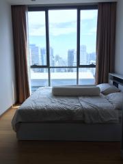 Modern bedroom with natural light and city view
