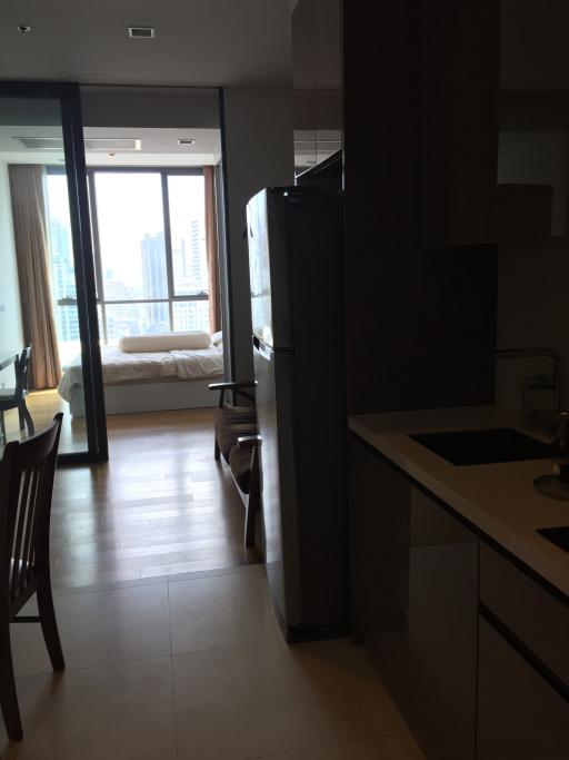 Modern kitchen with view towards the living area and balcony