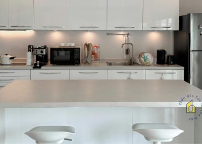 Modern kitchen with white cabinetry and stainless steel appliances