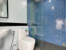 Modern bathroom with blue mosaic tiles and white fixtures