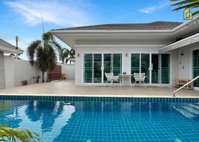 Modern home exterior with swimming pool and patio area