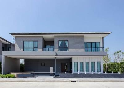 Modern two-story house with a gray facade and balcony