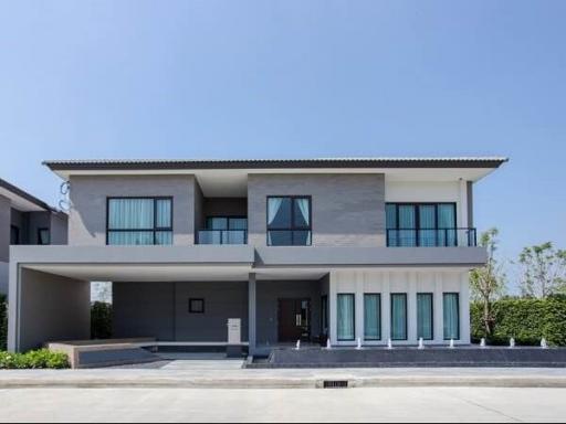 Modern two-story house with a gray facade and balcony